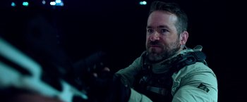 Movie still from “6 Underground” (2019), directed by Michael Bay – A person holding a camera; Close Up shot, Over the shoulder angle