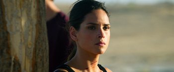 Movie still from “6 Underground” (2019), directed by Michael Bay – A person wearing a black shirt; Close Up shot, Over the shoulder angle