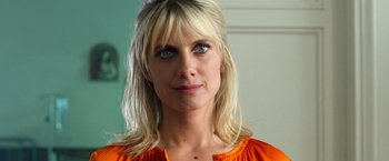 Movie still from “6 Underground” (2019), directed by Michael Bay – A woman with blonde hair wearing an orange shirt; Close Up shot, Low angle