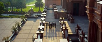 Movie still from “6 Underground” (2019), directed by Michael Bay – A group of people standing in a courtyard; Extreme Wide shot, High angle