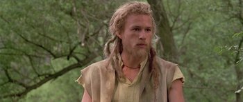 Movie still from “A Knight's Tale” (2001), directed by Brian Helgeland – A man with long blonde hair and a beard; Close Up shot, Low angle
