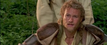 Movie still from “A Knight's Tale” (2001), directed by Brian Helgeland – A person with a beard; Close Up shot, Over the shoulder angle