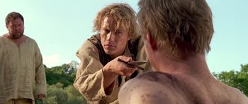 Movie still from “A Knight's Tale” (2001), directed by Brian Helgeland – A man is holding a pair of shears in his hand; Close Up shot, Over the shoulder angle