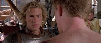 Movie still from “A Knight's Tale” (2001), directed by Brian Helgeland – A young man looking into a mirror while standing next to another young man; Close Up shot, Over the shoulder angle
