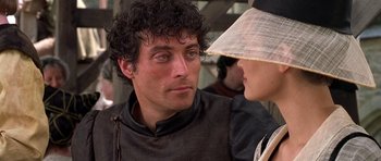 Movie still from “A Knight's Tale” (2001), directed by Brian Helgeland – A person with a hat; Close Up shot, Over the shoulder angle