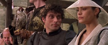 Movie still from “A Knight's Tale” (2001), directed by Brian Helgeland – A person with curly hair; Close Up shot, Over the shoulder angle