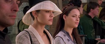 Movie still from “A Knight's Tale” (2001), directed by Brian Helgeland – Two women wearing hats are standing next to each other; Close Up shot, Low angle