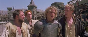 Movie still from “A Knight's Tale” (2001), directed by Brian Helgeland – A group of men standing next to each other; Medium shot, Low angle