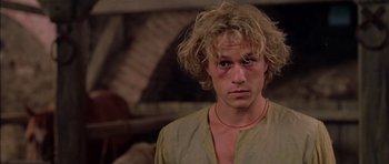 Movie still from “A Knight's Tale” (2001), directed by Brian Helgeland – A young man with blonde hair is looking at the camera; Close Up shot, Low angle