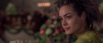 Movie still from “A Knight's Tale” (2001), directed by Brian Helgeland – A woman's face in front of a bunch of lights; Close Up shot, Over the shoulder angle