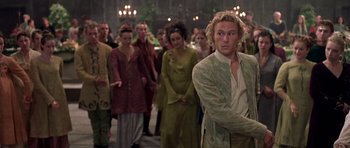 Movie still from “A Knight's Tale” (2001), directed by Brian Helgeland – A group of people walking down a street; Medium shot, Over the shoulder angle