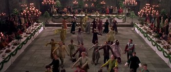 Movie still from “A Knight's Tale” (2001), directed by Brian Helgeland – A group of people dancing on a stone floor in front of a crowd of onlookers; Extreme Wide shot, High angle