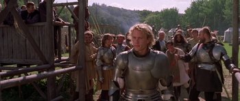 Movie still from “A Knight's Tale” (2001), directed by Brian Helgeland – A group of people standing next to each other in armor; Medium shot, Over the shoulder angle