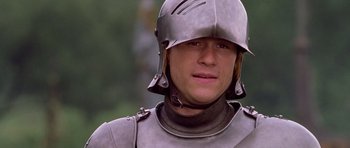 Movie still from “A Knight's Tale” (2001), directed by Brian Helgeland – A person wearing a suit of armor; Close Up shot, Low angle