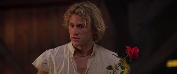 Movie still from “A Knight's Tale” (2001), directed by Brian Helgeland – A person holding a flower; Close Up shot, Over the shoulder angle