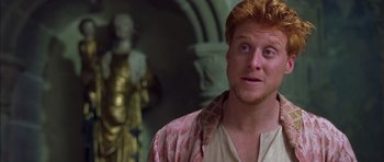 Movie still from “A Knight's Tale” (2001), directed by Brian Helgeland – A person wearing a shirt; Close Up shot, High angle