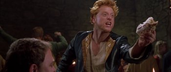 Movie still from “A Knight's Tale” (2001), directed by Brian Helgeland – A man in a leather jacket is yelling at something; Medium shot, Low angle