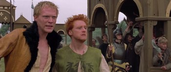Movie still from “A Knight's Tale” (2001), directed by Brian Helgeland – A group of men standing next to each other; Medium shot, Low angle