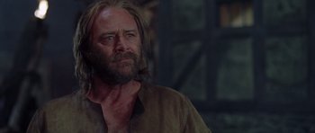 Movie still from “A Knight's Tale” (2001), directed by Brian Helgeland – A man with long hair and a beard looking to his left; Close Up shot, Low angle