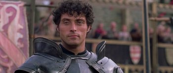 Movie still from “A Knight's Tale” (2001), directed by Brian Helgeland – A person wearing a suit of armor; Close Up shot, Over the shoulder angle