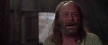 Movie still from “A Knight's Tale” (2001), directed by Brian Helgeland – An old man with long hair and a beard is crying; Close Up shot, Low angle
