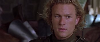 Movie still from “A Knight's Tale” (2001), directed by Brian Helgeland – A person wearing a helmet; Close Up shot, Over the shoulder angle