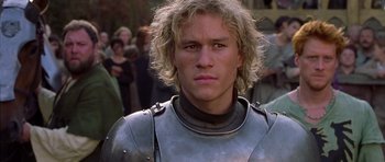 Movie still from “A Knight's Tale” (2001), directed by Brian Helgeland – A person wearing a suit of armor; Close Up shot, Over the shoulder angle