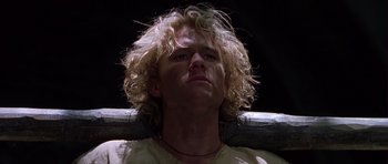 Movie still from “A Knight's Tale” (2001), directed by Brian Helgeland – A person with long blonde curly hair; Close Up shot, Low angle