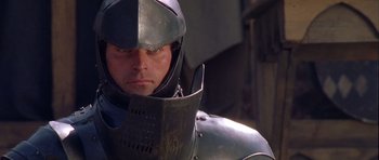 Movie still from “A Knight's Tale” (2001), directed by Brian Helgeland – A person wearing a suit of armor; Close Up shot, Over the shoulder angle