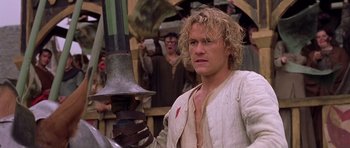 Movie still from “A Knight's Tale” (2001), directed by Brian Helgeland – A person holding a sword; Medium shot, Low angle
