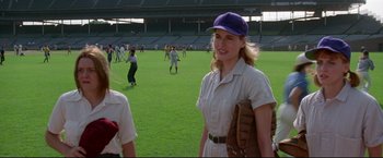 Movie still from “A League of Their Own” (1992), directed by Penny Marshall – A woman wearing a baseball uniform and a hat; Medium shot, Over the shoulder angle