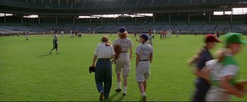 Movie still from “A League of Their Own” (1992), directed by Penny Marshall – A group of women walking across a baseball field; Wide shot, High angle