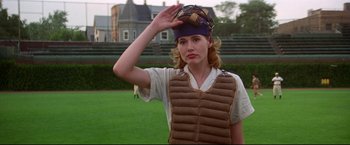 Movie still from “A League of Their Own” (1992), directed by Penny Marshall – A woman wearing a catcher's mitt on a baseball field; Medium shot, Low angle