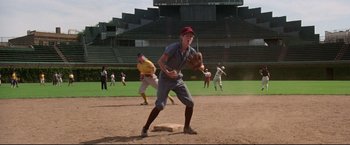 Movie still from “A League of Their Own” (1992), directed by Penny Marshall – A baseball player is ready to catch the ball; Wide shot, High angle