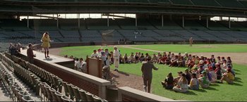 Movie still from “A League of Their Own” (1992), directed by Penny Marshall – A group of people standing on top of a baseball field; Extreme Wide shot, High angle
