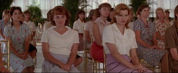 Movie still from “A League of Their Own” (1992), directed by Penny Marshall – A group of women sitting in a room; Medium shot, Over the shoulder angle
