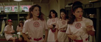 Movie still from “A League of Their Own” (1992), directed by Penny Marshall – A group of women standing next to each other in a room; Medium shot, Low angle