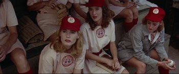 Movie still from “A League of Their Own” (1992), directed by Penny Marshall – A couple of women sitting next to each other on a field; Close Up shot, Low angle