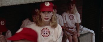 Movie still from “A League of Their Own” (1992), directed by Penny Marshall – A group of women in baseball uniforms in a dugout; Medium shot, Over the shoulder angle