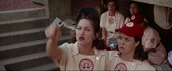 Movie still from “A League of Their Own” (1992), directed by Penny Marshall – A group of women in baseball uniforms holding a bat; Medium shot, Low angle