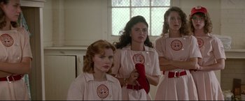 Movie still from “A League of Their Own” (1992), directed by Penny Marshall – A group of women standing next to each other in front of a window; Medium shot, Low angle