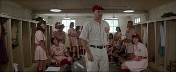 Movie still from “A League of Their Own” (1992), directed by Penny Marshall – A baseball player stands in front of a group of people; Wide shot, Low angle