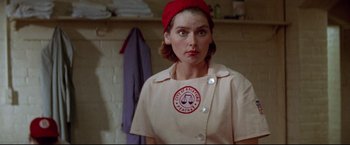 Movie still from “A League of Their Own” (1992), directed by Penny Marshall – A woman wearing a red hat in a room; Close Up shot, Low angle