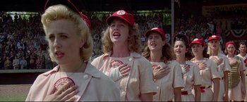 Movie still from “A League of Their Own” (1992), directed by Penny Marshall – A group of women standing next to each other in baseball uniforms; Medium shot, Low angle