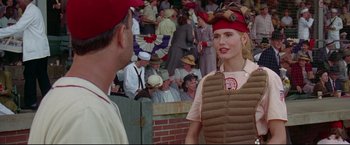 Movie still from “A League of Their Own” (1992), directed by Penny Marshall – A woman in a baseball uniform talking to a man in a catcher's uniform; Medium shot, Over the shoulder angle