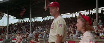 Movie still from “A League of Their Own” (1992), directed by Penny Marshall – A man in a baseball uniform standing in front of a crowd; Medium shot, Low angle