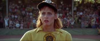 Movie still from “A League of Their Own” (1992), directed by Penny Marshall – A person wearing a baseball uniform; Close Up shot, Over the shoulder angle