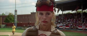 Movie still from “A League of Their Own” (1992), directed by Penny Marshall – A female baseball player wearing a catchers helmet; Close Up shot, Low angle