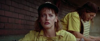Movie still from “A League of Their Own” (1992), directed by Penny Marshall – A person wearing a baseball uniform; Close Up shot, Over the shoulder angle