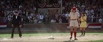 Movie still from “A League of Their Own” (1992), directed by Penny Marshall – A baseball player standing in front of a crowd of people; Wide shot, Low angle